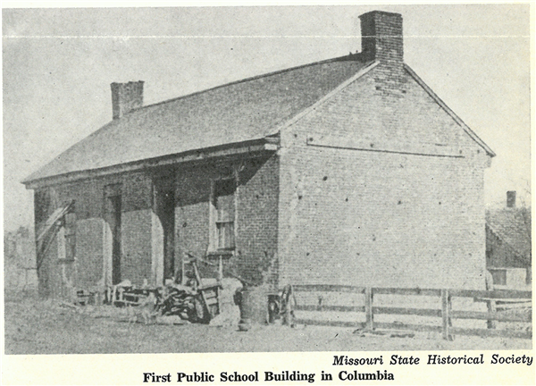An image of the First Public School Building. The photo is of a brick school house building on yellowed paper. An image of the First Public School Building. The photo is of a brick school house building on yellowed paper.
